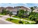 Beautiful single-Gathering home boasting a three-car garage, stone accents, meticulous landscaping, and a charming neighborhood setting at 1028 Signet Dr, Apollo Beach, FL 33572