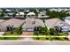 Beautiful home featuring a three-car garage, well-maintained landscaping, and elegant stone accents, with a paved driveway at 1028 Signet Dr, Apollo Beach, FL 33572