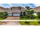 Beautiful single Gathering home with an attached three-car garage and meticulously manicured landscaping at 1028 Signet Dr, Apollo Beach, FL 33572