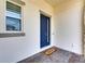 Welcoming front door with a welcome mat, adjacent to a window, and a sleek design at 1028 Signet Dr, Apollo Beach, FL 33572