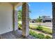 Charming covered front porch showing stone pillars, brick flooring, and a view of landscaped street at 1028 Signet Dr, Apollo Beach, FL 33572