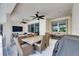 Outdoor patio area showcasing comfortable seating, an outdoor dining table, ceiling fans, and a view of the surrounding property at 1028 Signet Dr, Apollo Beach, FL 33572