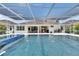 Gorgeous pool with a beautiful patio and screened-in enclosure for year-round enjoyment at 1028 Signet Dr, Apollo Beach, FL 33572