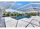 The pool has an intricate design and crystal-clear water, all screened in at 1028 Signet Dr, Apollo Beach, FL 33572