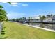 Waterfront views with a landscaped lawn and dock. Perfect for boaters! at 1028 Signet Dr, Apollo Beach, FL 33572