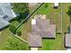 Aerial view of home featuring fenced yard, roof, and green surroundings at 1038 Shenandoah Ln, Spring Hill, FL 34606