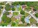 An aerial view showcases a neighborhood with well-maintained homes and mature trees at 1038 Shenandoah Ln, Spring Hill, FL 34606