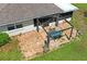 Aerial view of a patio featuring outdoor furniture, a well-maintained lawn, and the home's roof at 1038 Shenandoah Ln, Spring Hill, FL 34606