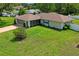 An aerial view showing the property's well-maintained lawn and landscaping at 1038 Shenandoah Ln, Spring Hill, FL 34606