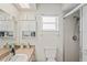 Bathroom with a window, neutral tones, vanity, and a tiled walk-in shower enclosure at 1038 Shenandoah Ln, Spring Hill, FL 34606