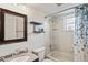Clean bathroom with tile flooring, neutral vanity, and a shower/tub combination with a curtain at 1038 Shenandoah Ln, Spring Hill, FL 34606