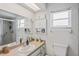 Well-lit bathroom with a window, neutral tones, vanity, and a walk-in shower enclosure at 1038 Shenandoah Ln, Spring Hill, FL 34606