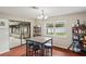 Dining area with hardwood floors, table seating for four and patio doors leading to the lanai at 1038 Shenandoah Ln, Spring Hill, FL 34606