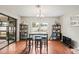 Dining area with hardwood floors, table seating for four and patio doors leading to the lanai at 1038 Shenandoah Ln, Spring Hill, FL 34606