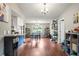 Open concept dining room with hardwood floors, open kitchen, and seating for four at 1038 Shenandoah Ln, Spring Hill, FL 34606