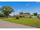 Well-manicured front yard with mature trees, offering shade and curb appeal at 1038 Shenandoah Ln, Spring Hill, FL 34606