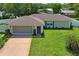 Exterior shot of a well-kept home with a two car garage and manicured lawn at 1038 Shenandoah Ln, Spring Hill, FL 34606