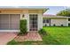 Close up view of a brick path leading to the screened front entryway and attached garage at 1038 Shenandoah Ln, Spring Hill, FL 34606