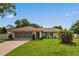 Charming single-story home with a well-maintained lawn and a two-car garage at 1038 Shenandoah Ln, Spring Hill, FL 34606