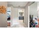 Hallway with access to bedrooms and kitchen featuring tile flooring and neutral walls at 1038 Shenandoah Ln, Spring Hill, FL 34606