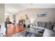 Bright living room with wood flooring, vaulted ceilings, and a large sectional couch at 1038 Shenandoah Ln, Spring Hill, FL 34606