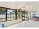 Enclosed sunroom with tile flooring, bright windows, and natural light leading to an outdoor patio at 1038 Shenandoah Ln, Spring Hill, FL 34606