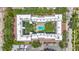 Aerial view of an apartment complex featuring an inner courtyard and swimming pool surrounded by lush trees at 105 4Th Ne Ave # 426, St Petersburg, FL 33701