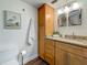 Bathroom with wood vanity, granite countertop, stylish mirrors and tiled floors at 105 4Th Ne Ave # 426, St Petersburg, FL 33701