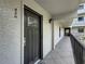 Condo exterior view featuring a dark front door with sidelight and balcony with black metal railing at 105 4Th Ne Ave # 426, St Petersburg, FL 33701