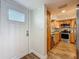 Updated kitchen featuring wood cabinets, stainless steel appliances, wood-look flooring, and a white door at 105 4Th Ne Ave # 426, St Petersburg, FL 33701