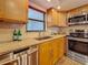 Kitchen area featuring wood cabinets, granite countertops, stainless steel appliances, and mosaic backsplash at 105 4Th Ne Ave # 426, St Petersburg, FL 33701