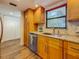 Bright kitchen with wooden cabinets, granite countertops, stainless steel appliances, and wood-look floors at 105 4Th Ne Ave # 426, St Petersburg, FL 33701