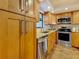 Kitchen featuring wooden cabinets, granite countertops, stainless steel appliances, and mosaic backsplash at 105 4Th Ne Ave # 426, St Petersburg, FL 33701