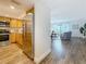 Open-concept kitchen with wood cabinets, stainless steel appliances, wood floors, and access to the living room at 105 4Th Ne Ave # 426, St Petersburg, FL 33701