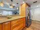 Bright kitchen featuring granite countertops, stainless steel refrigerator, and wood cabinets at 105 4Th Ne Ave # 426, St Petersburg, FL 33701