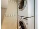Laundry room with a stacked washer and dryer, complemented by a row of hooks on the wall at 105 4Th Ne Ave # 426, St Petersburg, FL 33701