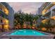 Community pool with palm trees and lights at dusk at 105 4Th Ne Ave # 426, St Petersburg, FL 33701
