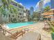 Relaxing outdoor pool area with comfortable lounge chairs in a tropical resort setting at 105 4Th Ne Ave # 426, St Petersburg, FL 33701