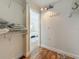 Walk-in closet leading to bedroom and featuring built-in shelving and wood look floors at 105 4Th Ne Ave # 426, St Petersburg, FL 33701