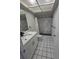 Modern bathroom with sleek vanity, black and white tile, and a spacious shower with marble tile at 1107 Queen Anne Dr # C, Palm Harbor, FL 34684