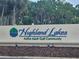 Highland Lakes Active Adult Golf Community sign with well maintained landscaping at 1107 Queen Anne Dr # C, Palm Harbor, FL 34684