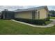 Charming single-story home featuring manicured lawn, walkway, and exterior with light yellow paint at 1107 Queen Anne Dr # C, Palm Harbor, FL 34684