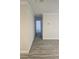 Hallway featuring attractive wood-look floors and freshly painted walls at 1107 Queen Anne Dr # C, Palm Harbor, FL 34684
