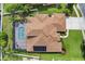 Bird's-eye view of a home highlighting the roof, solar panels, screened pool area, and manicured landscaping at 111 Falling Water Dr, Brandon, FL 33511