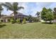 A view of the backyard, swimming pool, screened patio and tropical landscaping at 111 Falling Water Dr, Brandon, FL 33511
