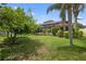 Lush backyard featuring a screened pool enclosure, mature trees, and verdant lawn for relaxation and recreation at 111 Falling Water Dr, Brandon, FL 33511