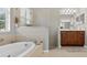 Bathroom featuring tub, frameless glass shower, and neutral color palette at 111 Falling Water Dr, Brandon, FL 33511