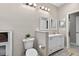 Cozy bathroom with a toilet, double vanity, decorative mirrors, and neutral-toned walls at 111 Falling Water Dr, Brandon, FL 33511