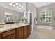Spacious bathroom featuring a soaking tub with jets and dark wood cabinets at 111 Falling Water Dr, Brandon, FL 33511
