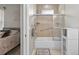 Bright bathroom with a shower/tub combo with glass doors and a cabinet for storage at 111 Falling Water Dr, Brandon, FL 33511